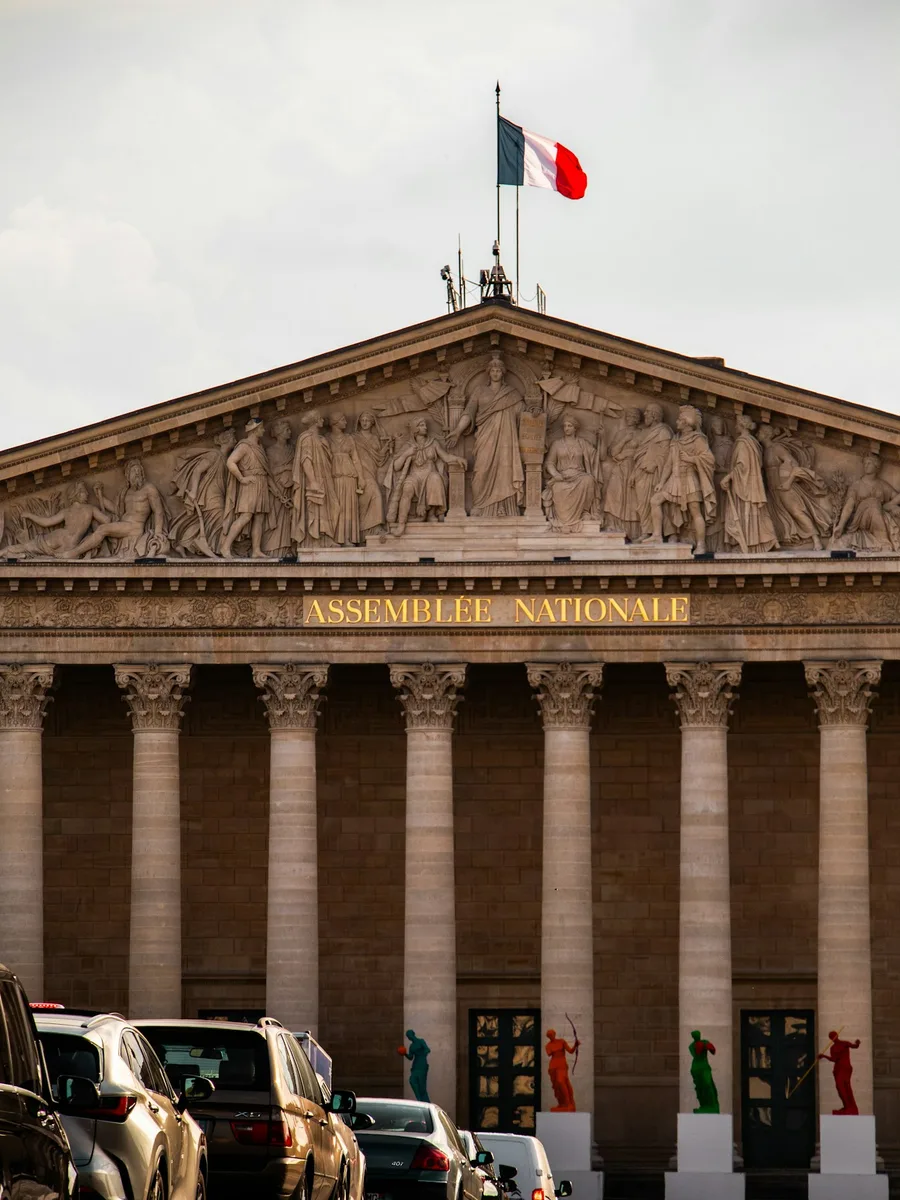 La façade à colonnes du Palais-Bourbon, siège de l'Assemblée nationale, surmontée d'un drapeau français